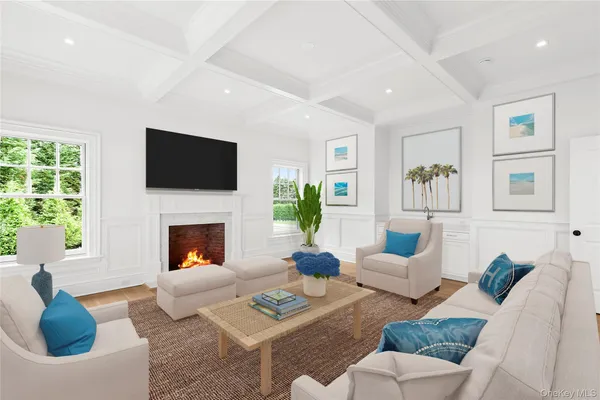 an empty room with wooden floor a fireplace and windows
