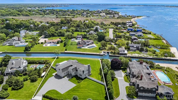 an aerial view of a swimming pool a yard and mountain view in back