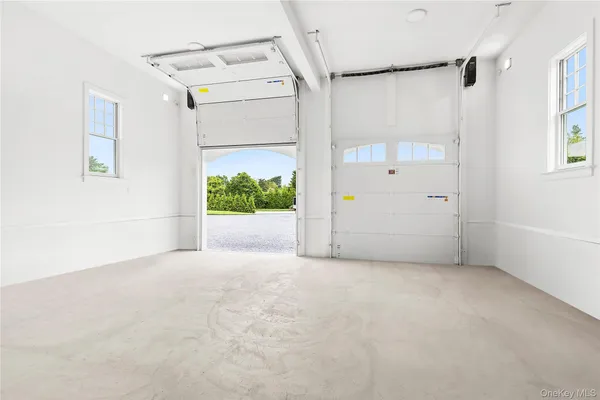 a large white kitchen with lots of counter top space and stainless steel appliances