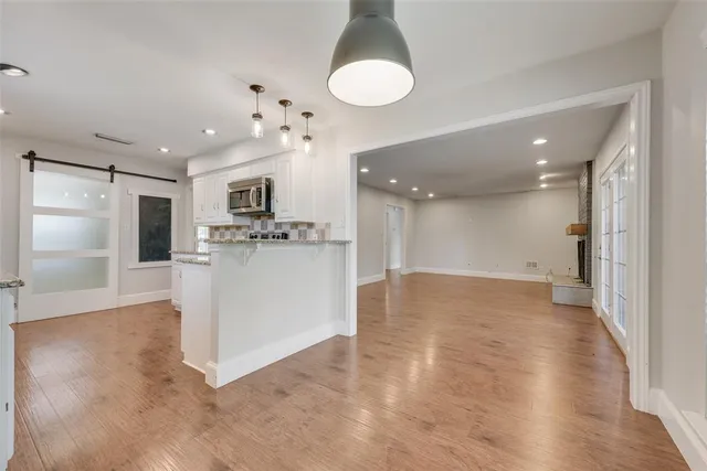 a view of a kitchen with a sink hardwood floor and a kitchen