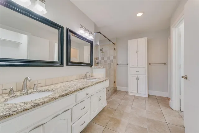 a bathroom with a granite countertop sink mirror and