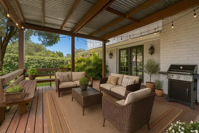 a outdoor living space with patio furniture and wooden floor