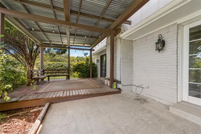 a view of backyard of house with green space