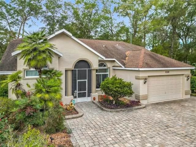 a view of a patio with a table chairs and a floor to ceiling window