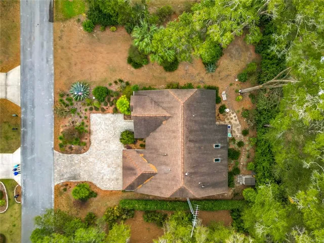 an aerial view of a house with yard