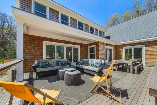 a view of a house with swimming pool and sitting area