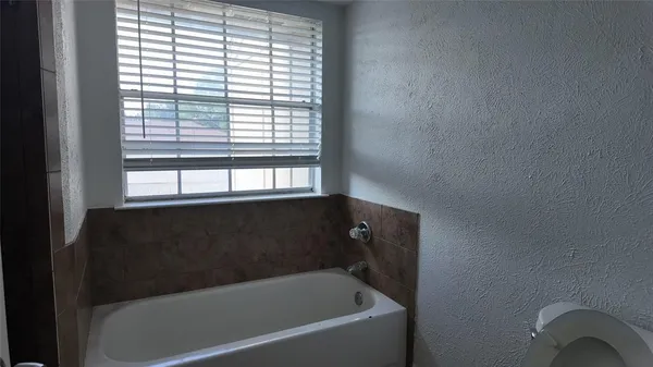 a bathroom with a bathtub and window