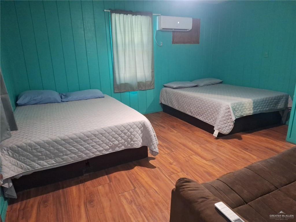 36789 Marshall Hutts Road Rio Hondo, TX 78583 - Photo 5 of 7 a bedroom with a bed and a wooden floor