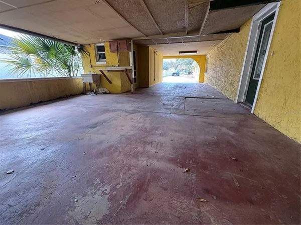 a view of work space with furniture and windows