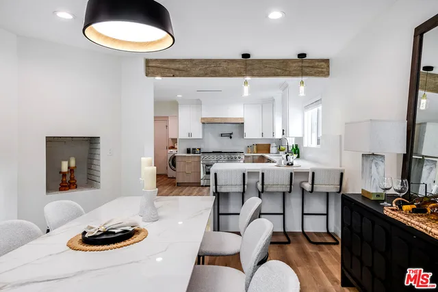 a living room with furniture kitchen and a table