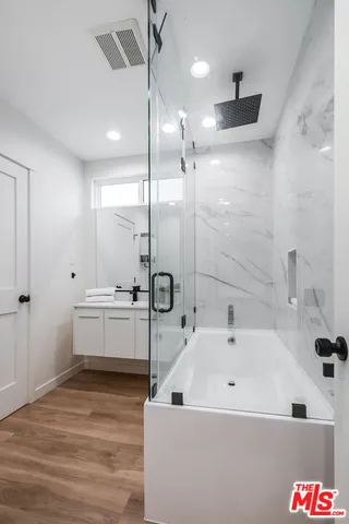 a bathroom with a bathtub and a shower