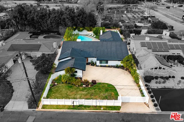 an aerial view of a house with a yard basket ball court and outdoor seating