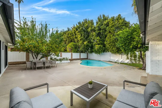 a view of a swimming pool with lounge chair
