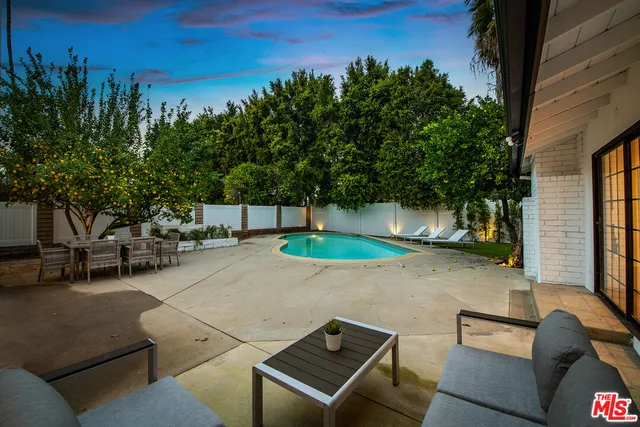 a view of a two chairs in the patio