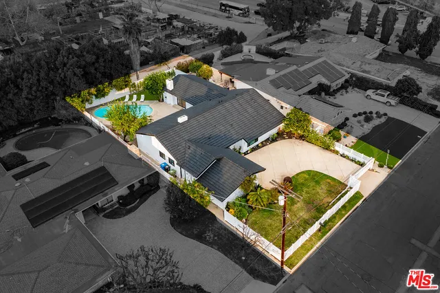 an aerial view of a house with a yard