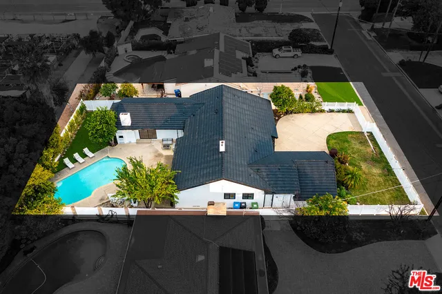 an aerial view of a house with a yard