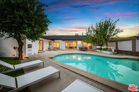 a view of house with swimming pool outdoor seating
