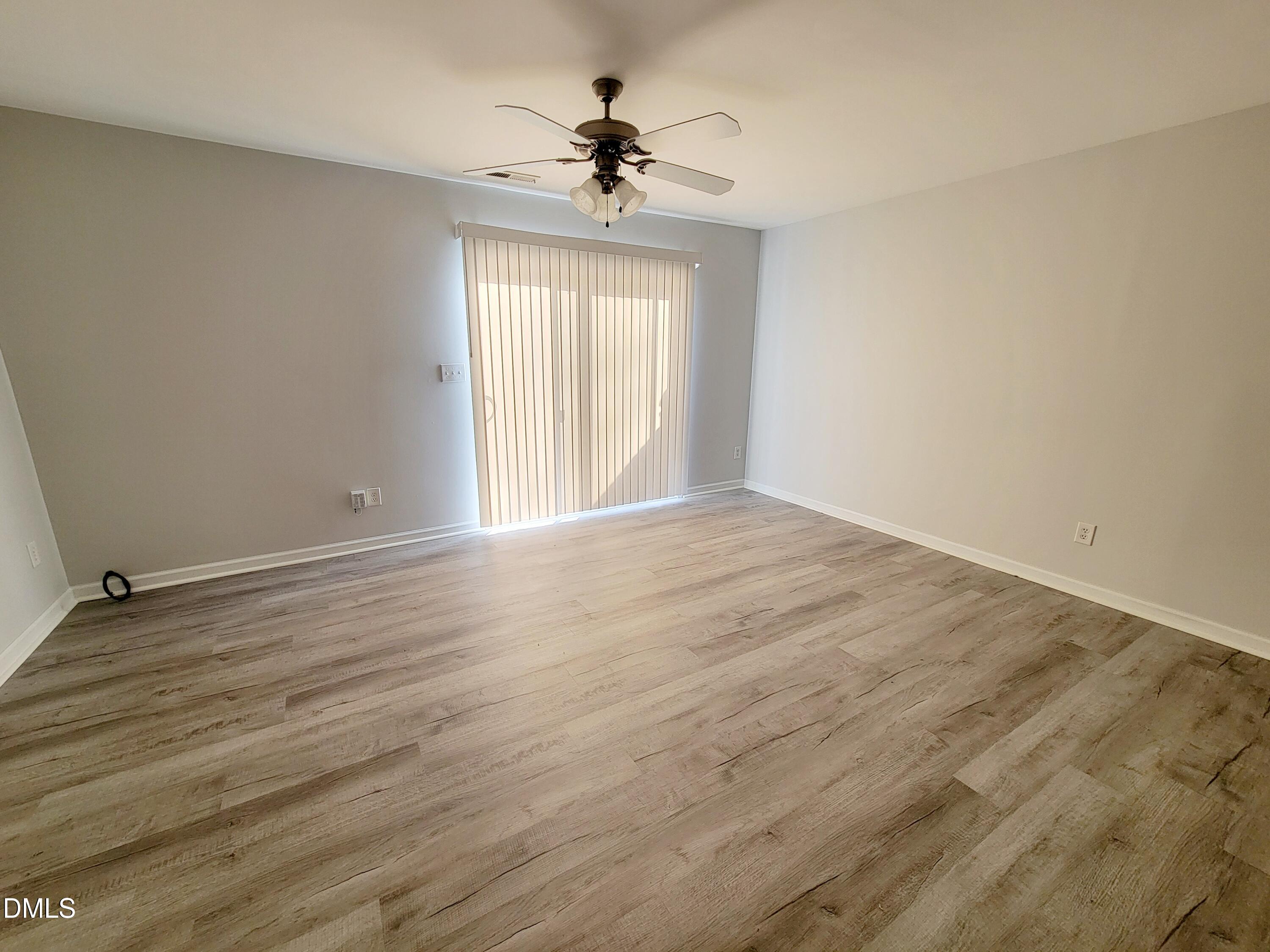 1407 Plexor Lane Knightdale, NC 27545 - Photo 12 of 43 wooden floor in an empty room with a window