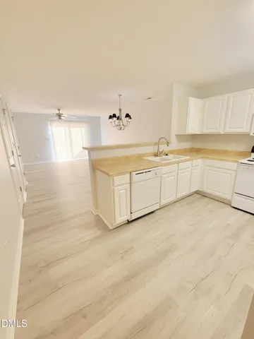 an empty room with wooden floor and white walls