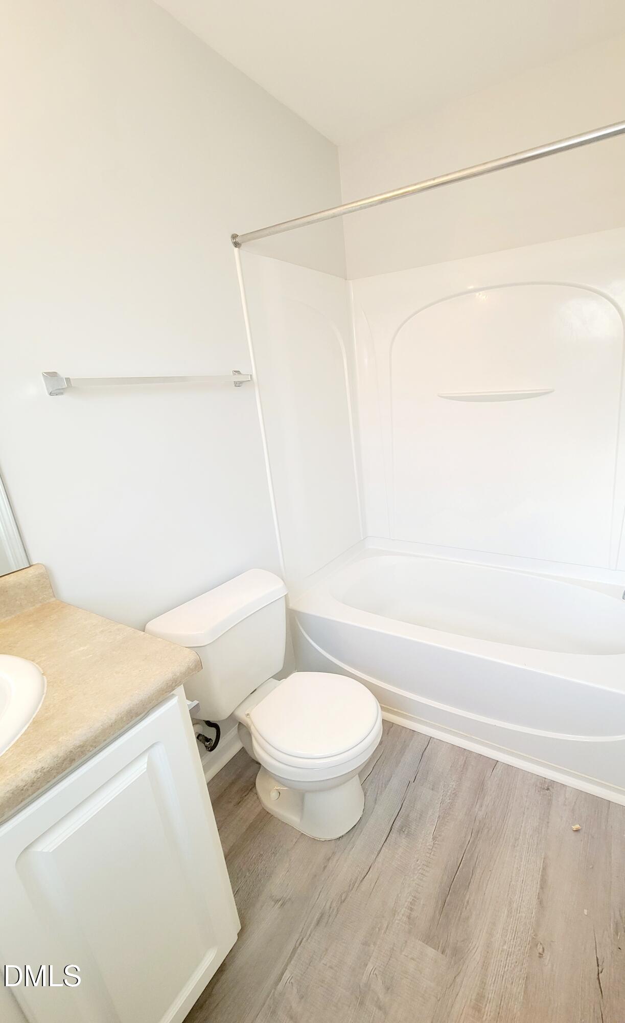 1407 Plexor Lane Knightdale, NC 27545 - Photo 25 of 43 a white toilet sitting next to a bathroom sink and vanity