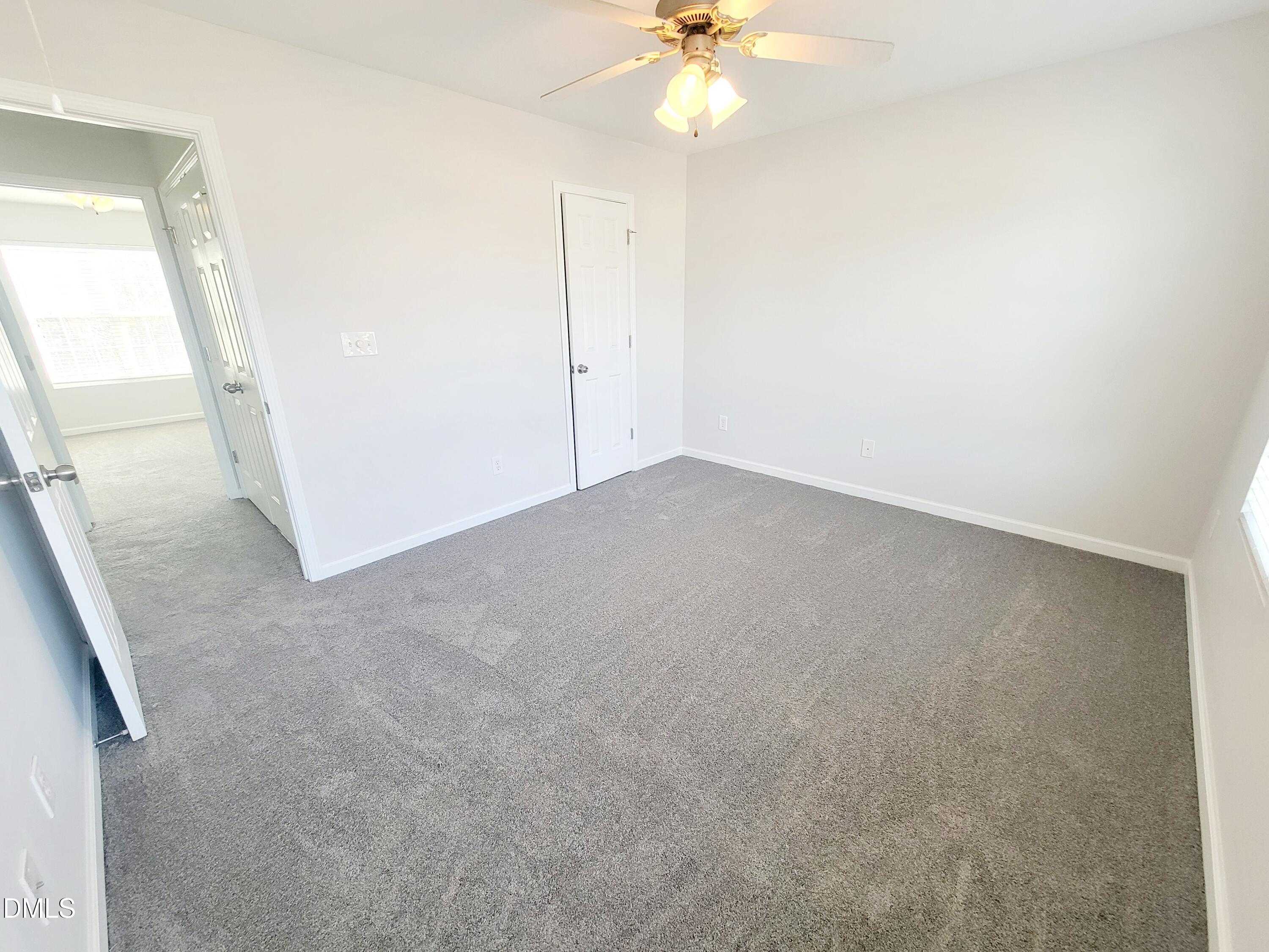 1407 Plexor Lane Knightdale, NC 27545 - Photo 28 of 43 an empty room with a chandelier fan
