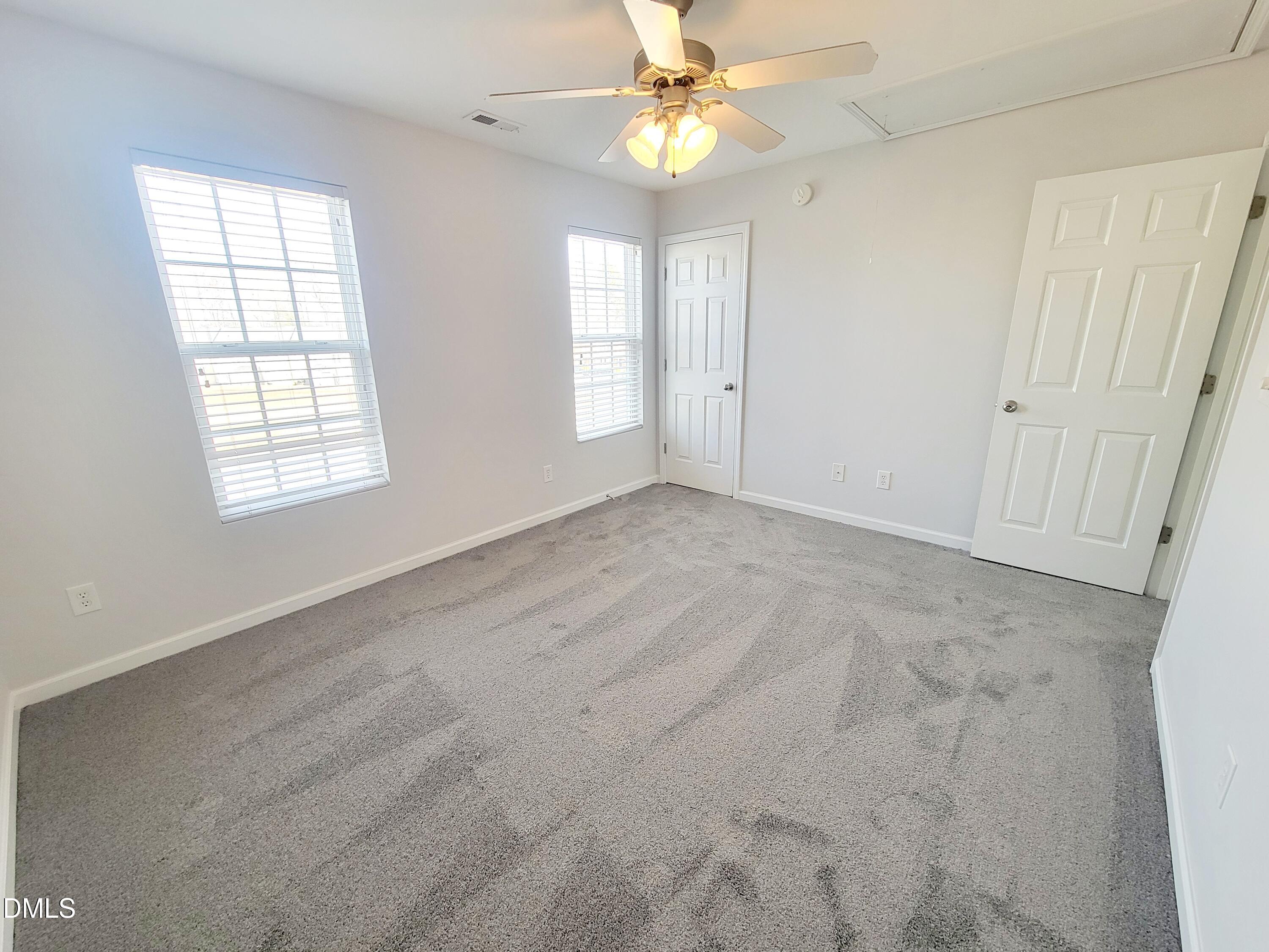 1407 Plexor Lane Knightdale, NC 27545 - Photo 30 of 43 an empty room with windows and fan