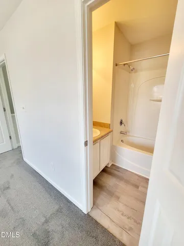 a bathroom with a tub a sink and a shower