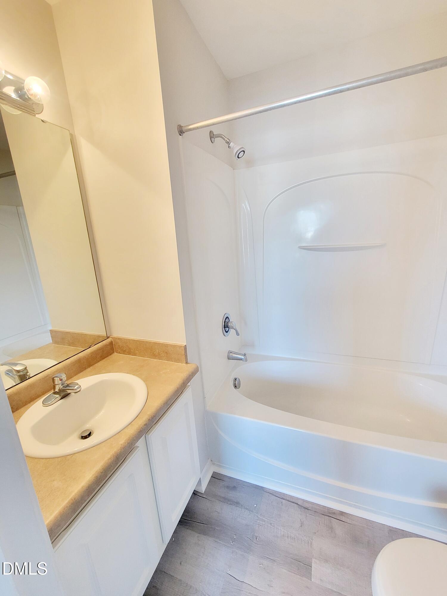 1407 Plexor Lane Knightdale, NC 27545 - Photo 34 of 43 a bathroom with a tub a sink and a shower