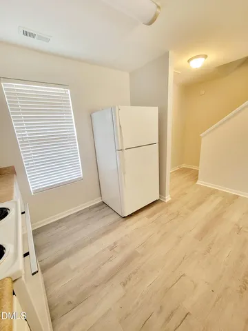 a room with granite countertop a sink and a mirror