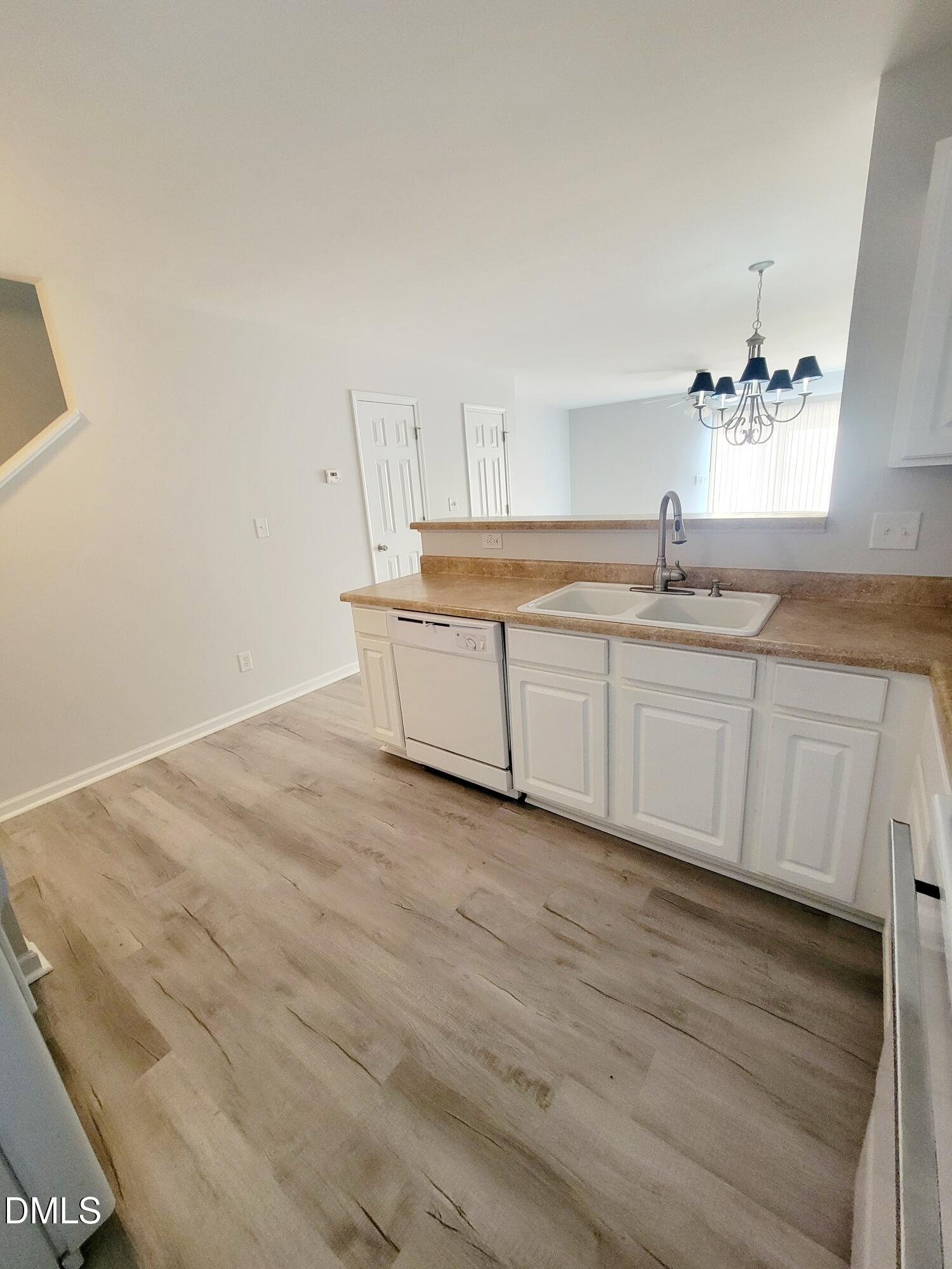 1407 Plexor Lane Knightdale, NC 27545 - Photo 7 of 43 a room with granite countertop a sink and a mirror