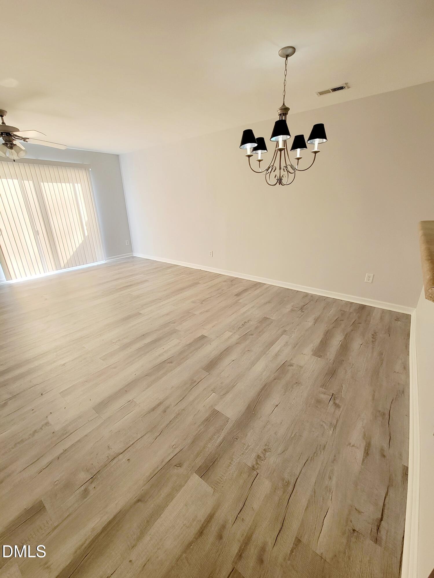 1407 Plexor Lane Knightdale, NC 27545 - Photo 8 of 43 a view of a room with wooden floor chandelier and windows