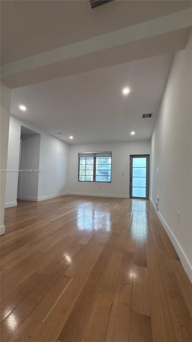 2021 Meridian Avenue, Unit 11 Miami Beach, FL 33139 - Photo 4 of 22 wooden floor in an empty room with a window