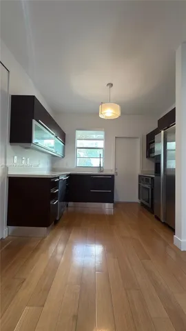 a kitchen with stainless steel appliances granite countertop a sink and cabinets