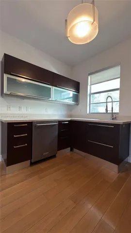 a living room with stainless steel appliances furniture and a fireplace