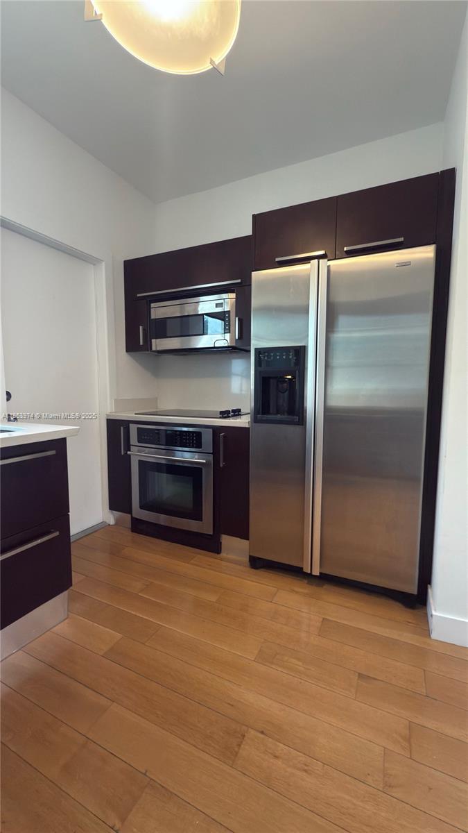 2021 Meridian Avenue, Unit 11 Miami Beach, FL 33139 - Photo 8 of 22 a living room with stainless steel appliances furniture and a fireplace