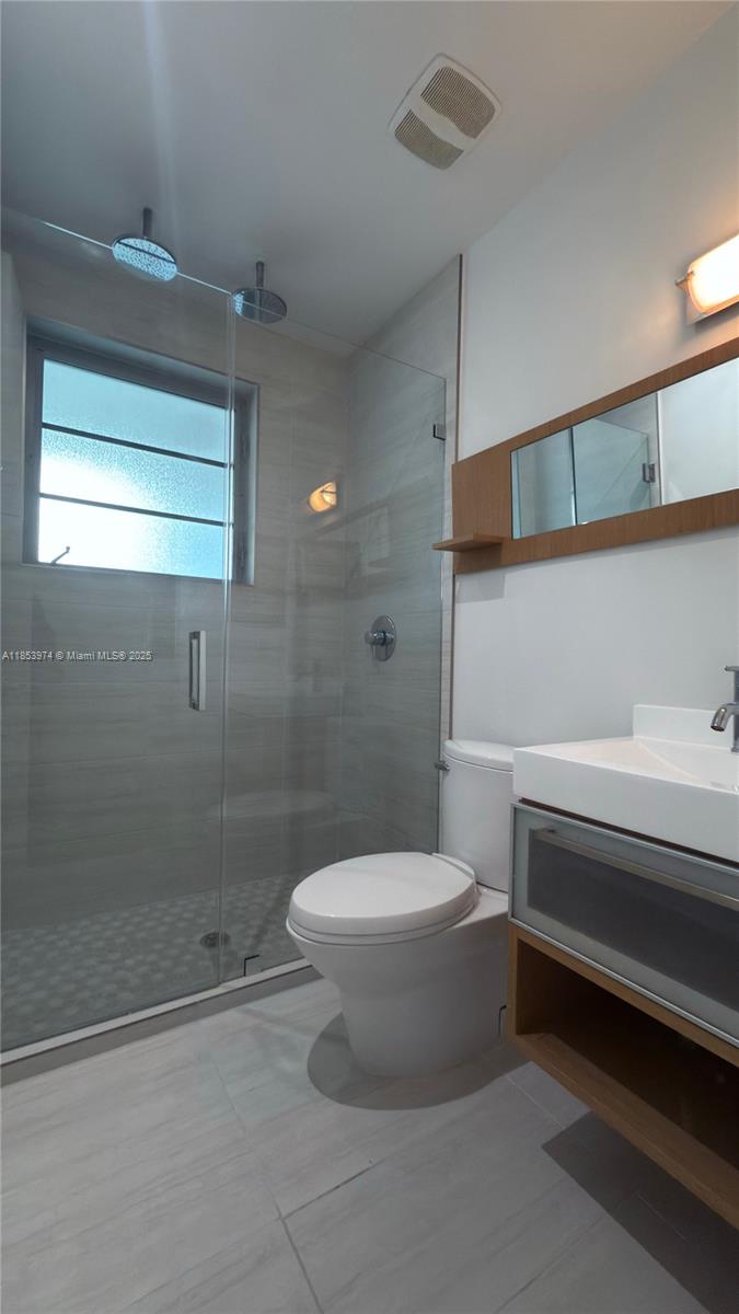 2021 Meridian Avenue, Unit 11 Miami Beach, FL 33139 - Photo 10 of 22 a bathroom with a toilet and a shower