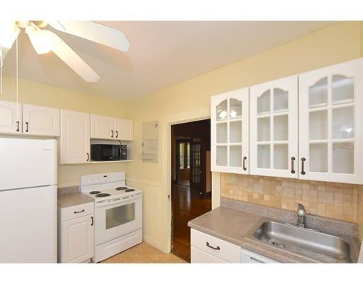 151 Cherry Street Ashland, MA 01721 - Photo 12 of 42 a kitchen with kitchen island a sink appliances and cabinets