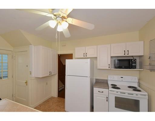 151 Cherry Street Ashland, MA 01721 - Photo 13 of 42 a kitchen with stainless steel appliances a refrigerator a stove a microwave oven with white cabinets