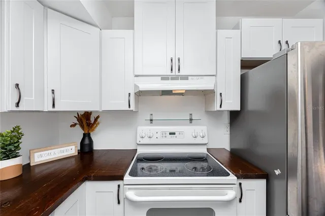 a kitchen with appliances cabinets and a counter top space