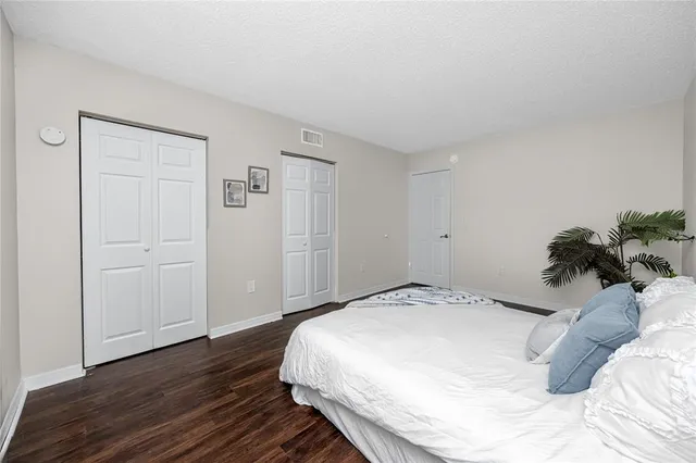 a bedroom with a bed and a potted plant