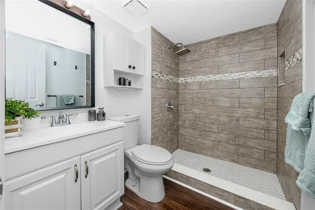 a bathroom with a sink toilet and shower