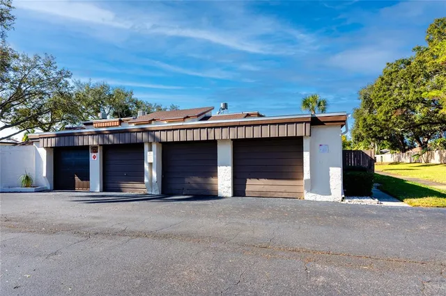 a view of a house with a garage and a yard