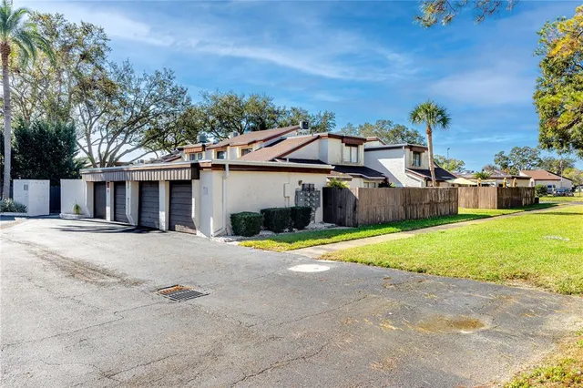 a view of an house with backyard and road