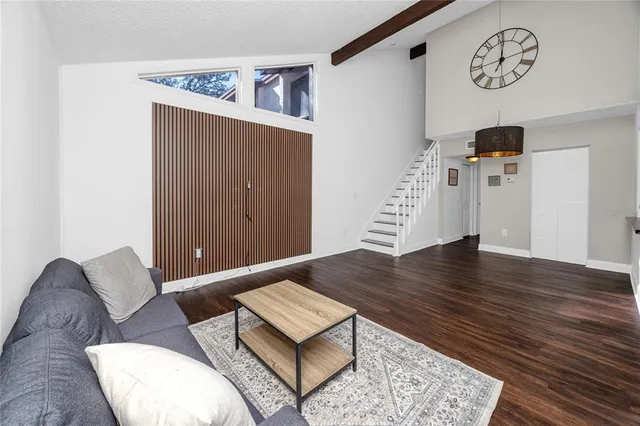 a view of a bedroom with furniture and wooden floor