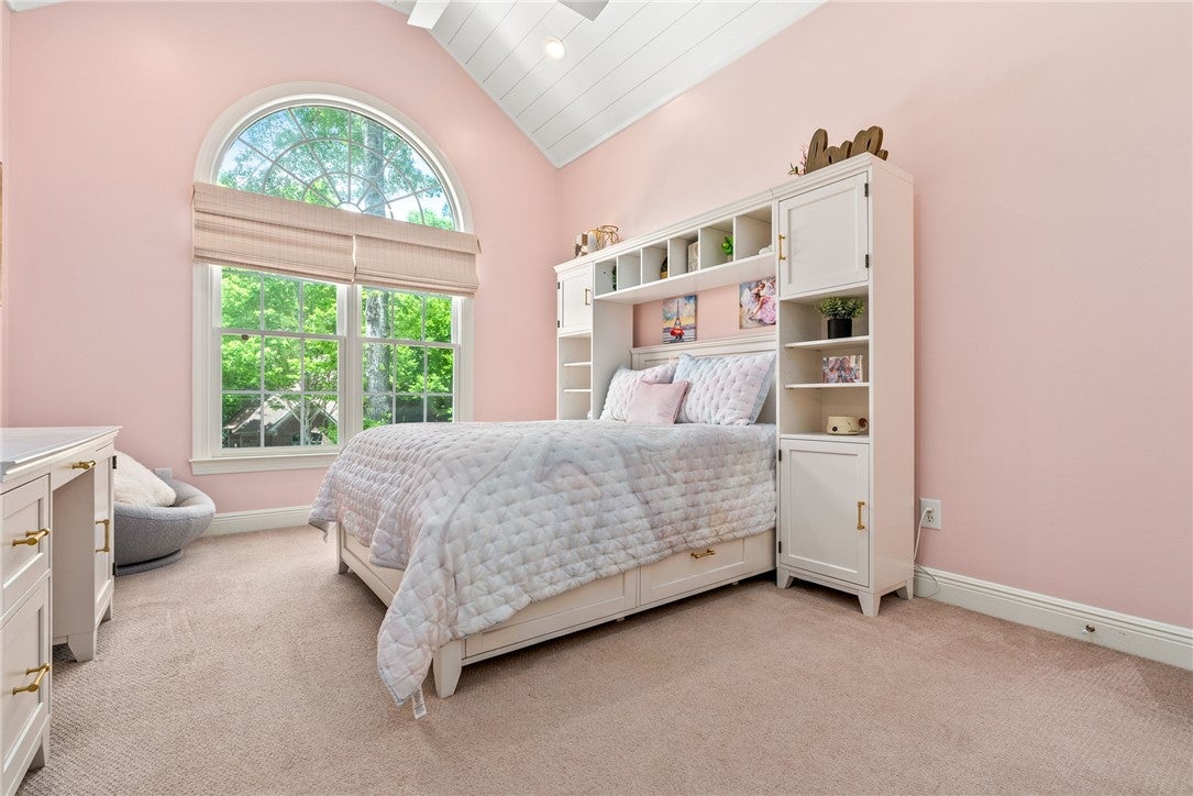 1657 Abby Road Auburn, AL 36830 - Photo 23 of 39 This inviting bedroom features vaulted ceilings and ample natural light, creating a bright and airy retreat.