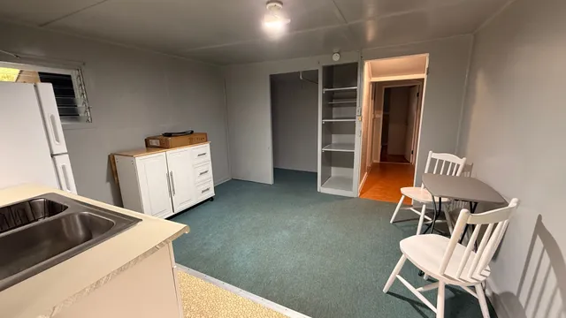 a kitchen with furniture a refrigerator and a stove