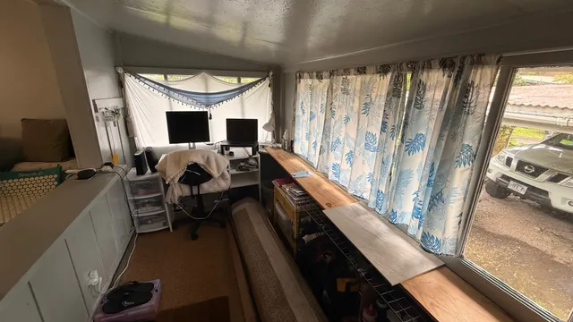 a bed room with a bed and a television