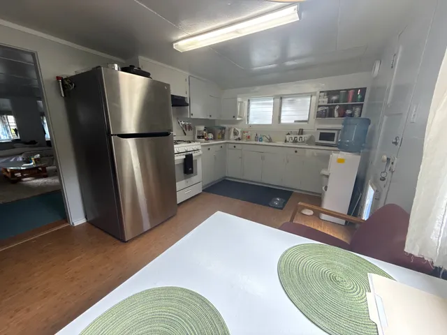 a kitchen with sink refrigerator and window
