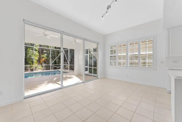 a large white kitchen with cabinets and a sink