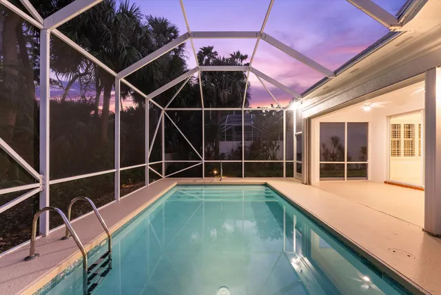 a view of a balcony with floor to ceiling windows and wooden floor